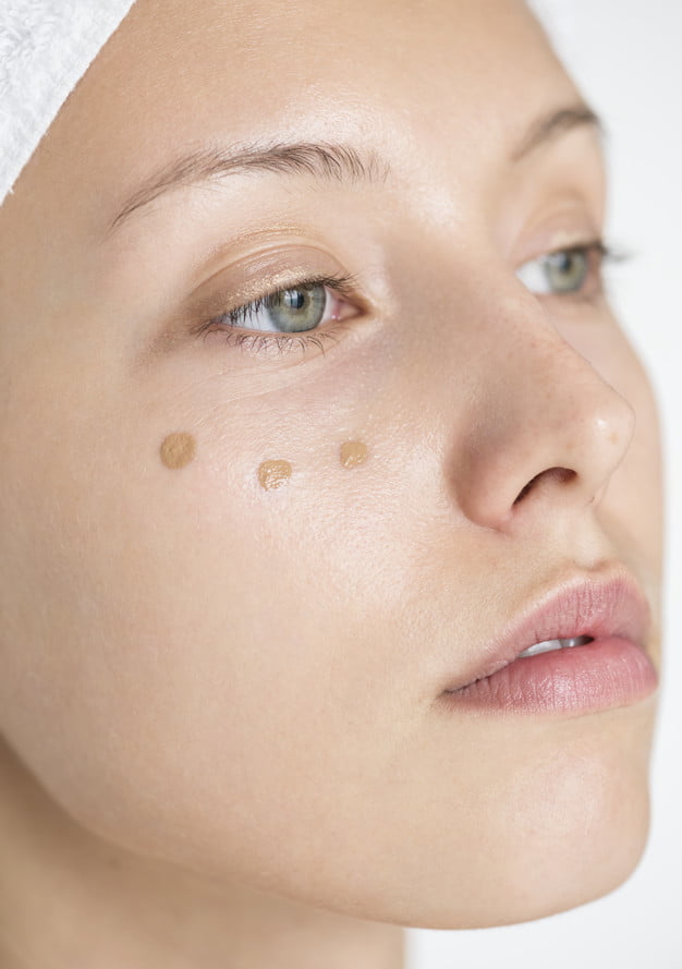 Portrait of white woman doing her daily makeup routine